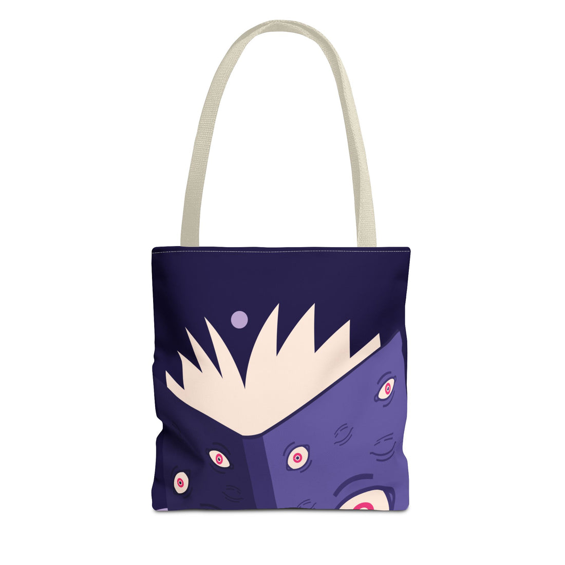 A canvas tote bag with a dark purple and blue cartoon monster face print, featuring a cream-colored handle and a cream-colored spiky graphic on the front.